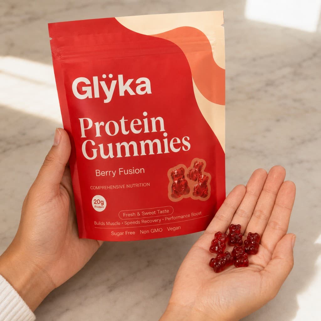 Hand holding Glÿka protein gummies and pouch